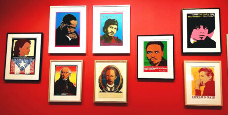 a red museum wall with silkscreened portraits of Lolita Le Born, Angela Davis, MLK, José Martí, Victor Jara, Edward Said and Miguel Hidalgo de Costilla