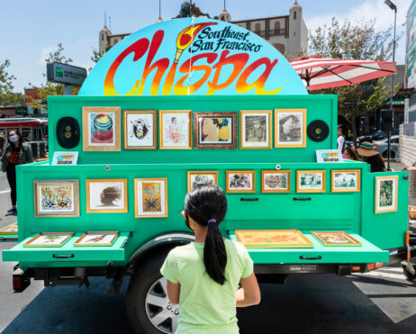 The Chispa Art Cart with a young participant in front.