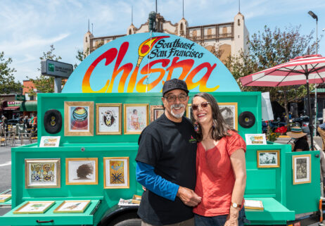 Oscar and Kate standing in front of the Chispa cart